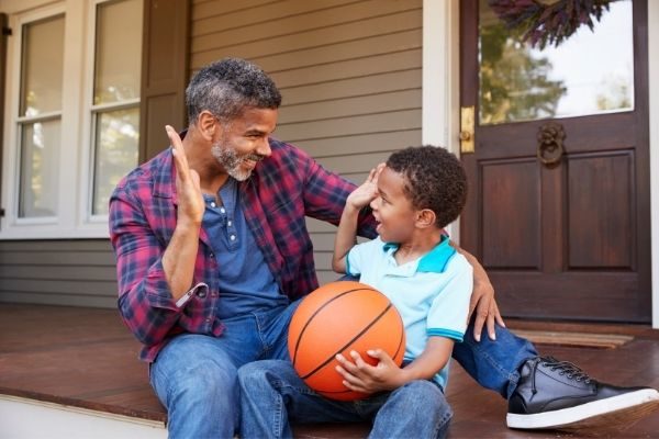 dad and son high five