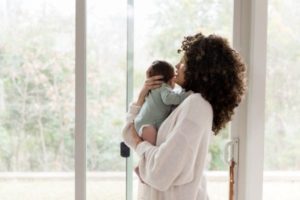 Mom holding baby: postpartum care package ideas on Amazon