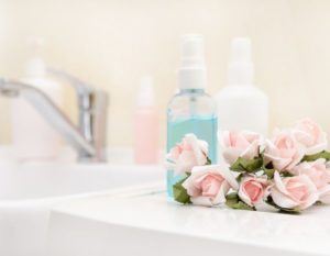 Self care assessment quiz, bottles and flowers on a counter
