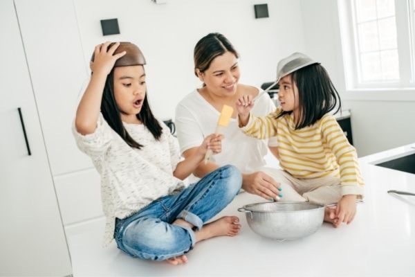 girls playing with mom in the kitchen