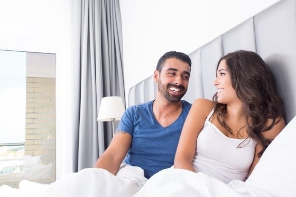 couple in bed, intimacy is important for love goals in your marriage