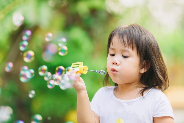 girl blowing bubbles