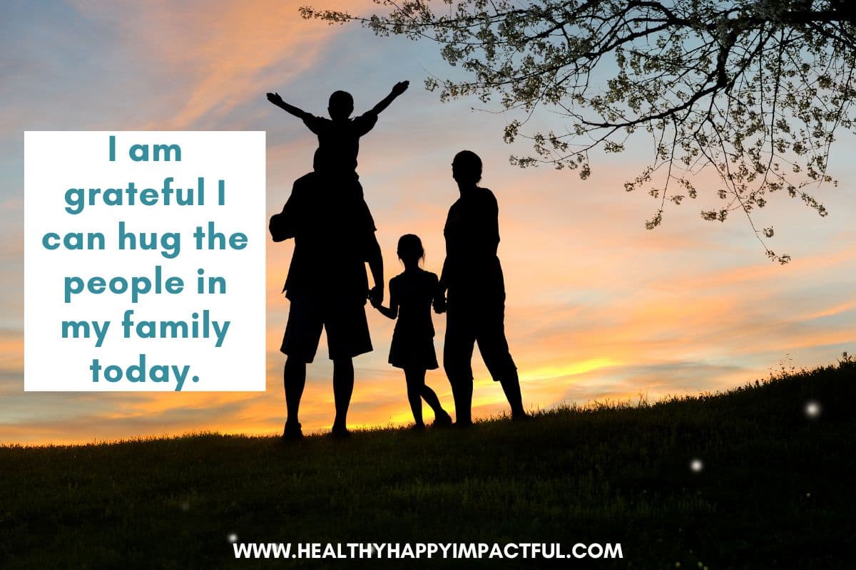 family holding kids in sunset; family affirmations on gratitude