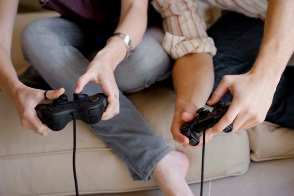 couple playing video games at home; date night ideas for married