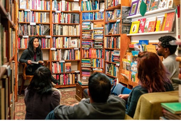 author reading book in library; literary quiz questions