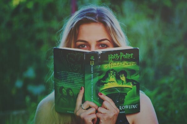 woman reading Harry Potter book; harry potter quiz with answers