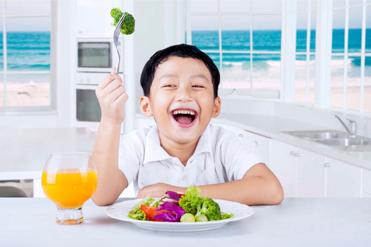 boy eating food and smiling