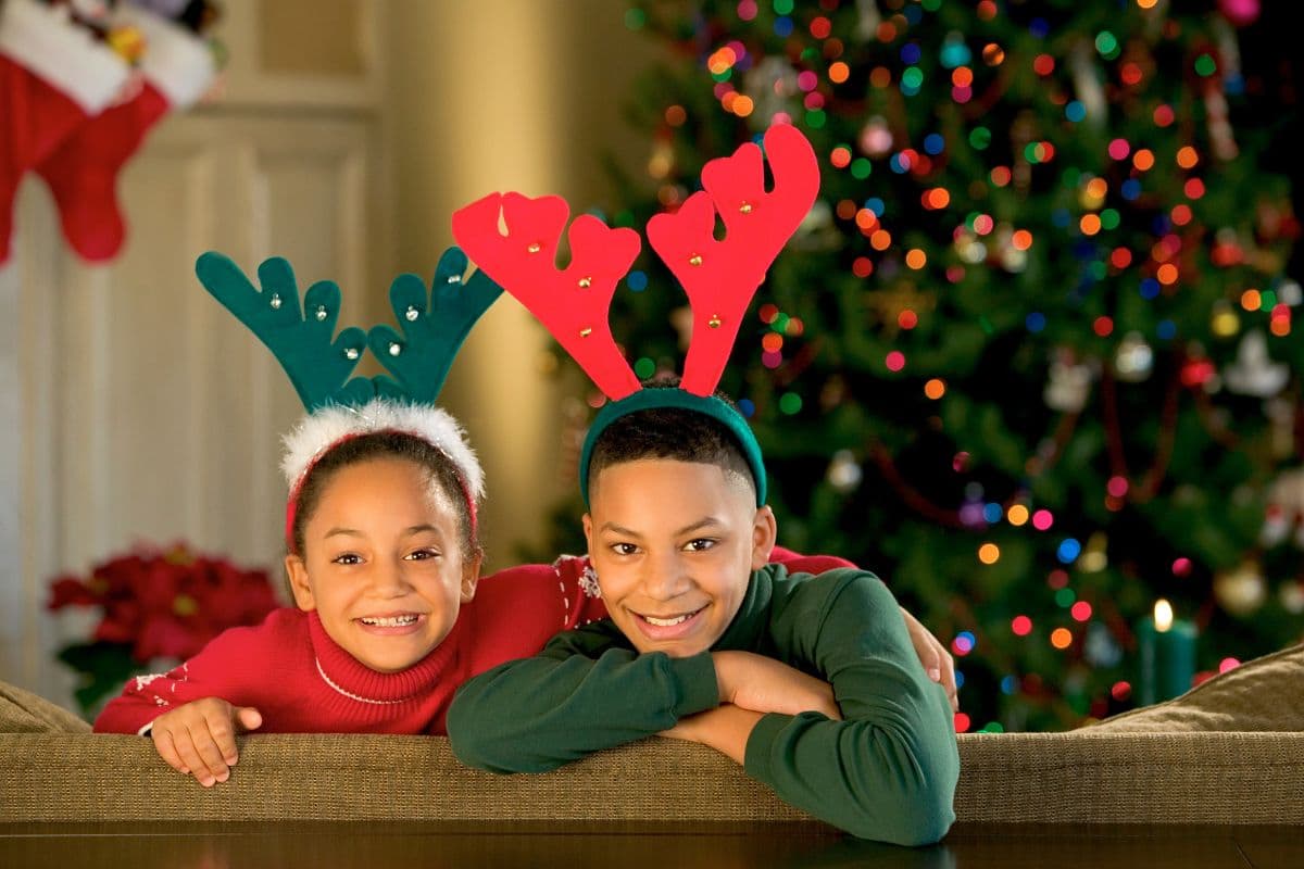 two kids with reindeer headbands