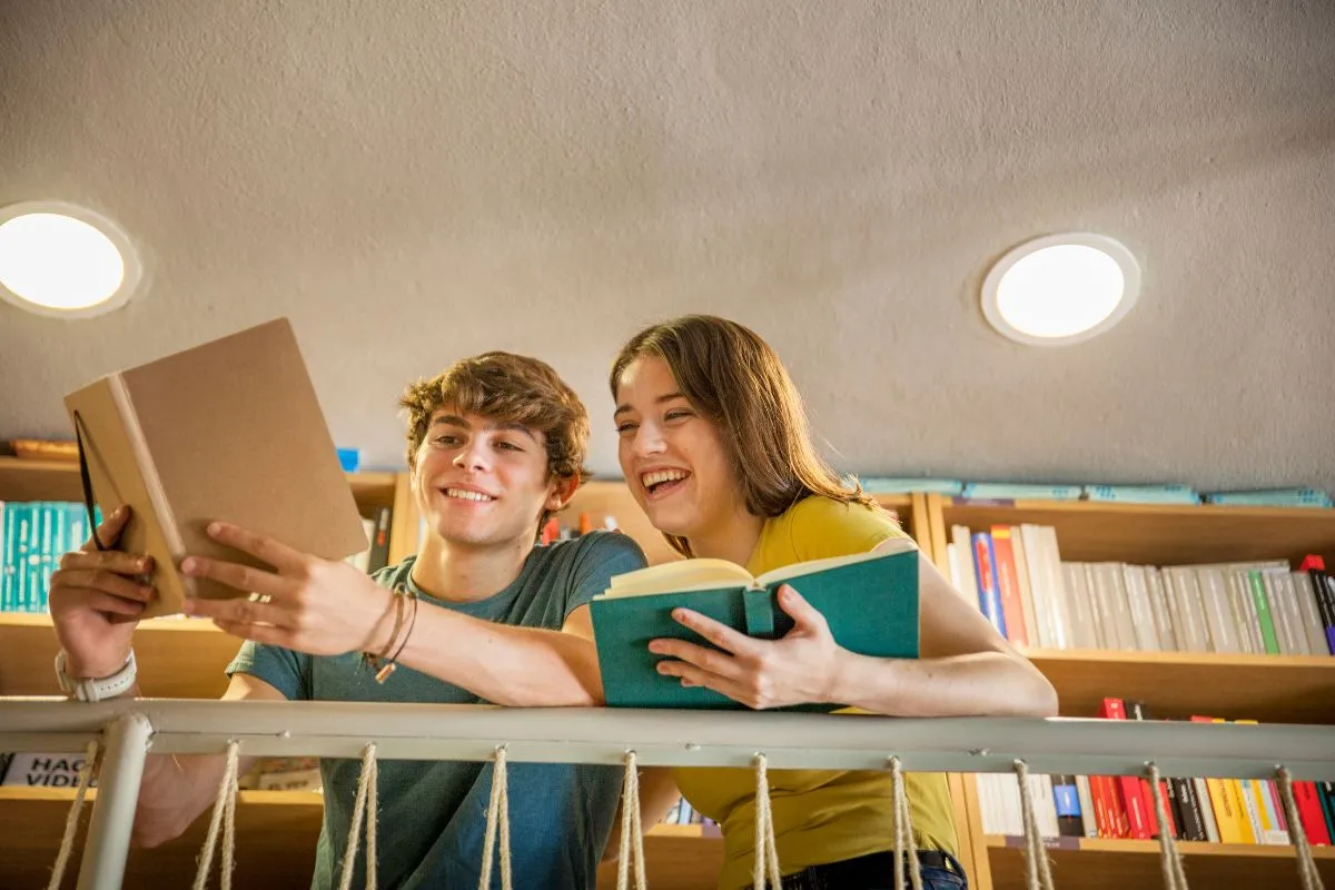 two teens looking at books