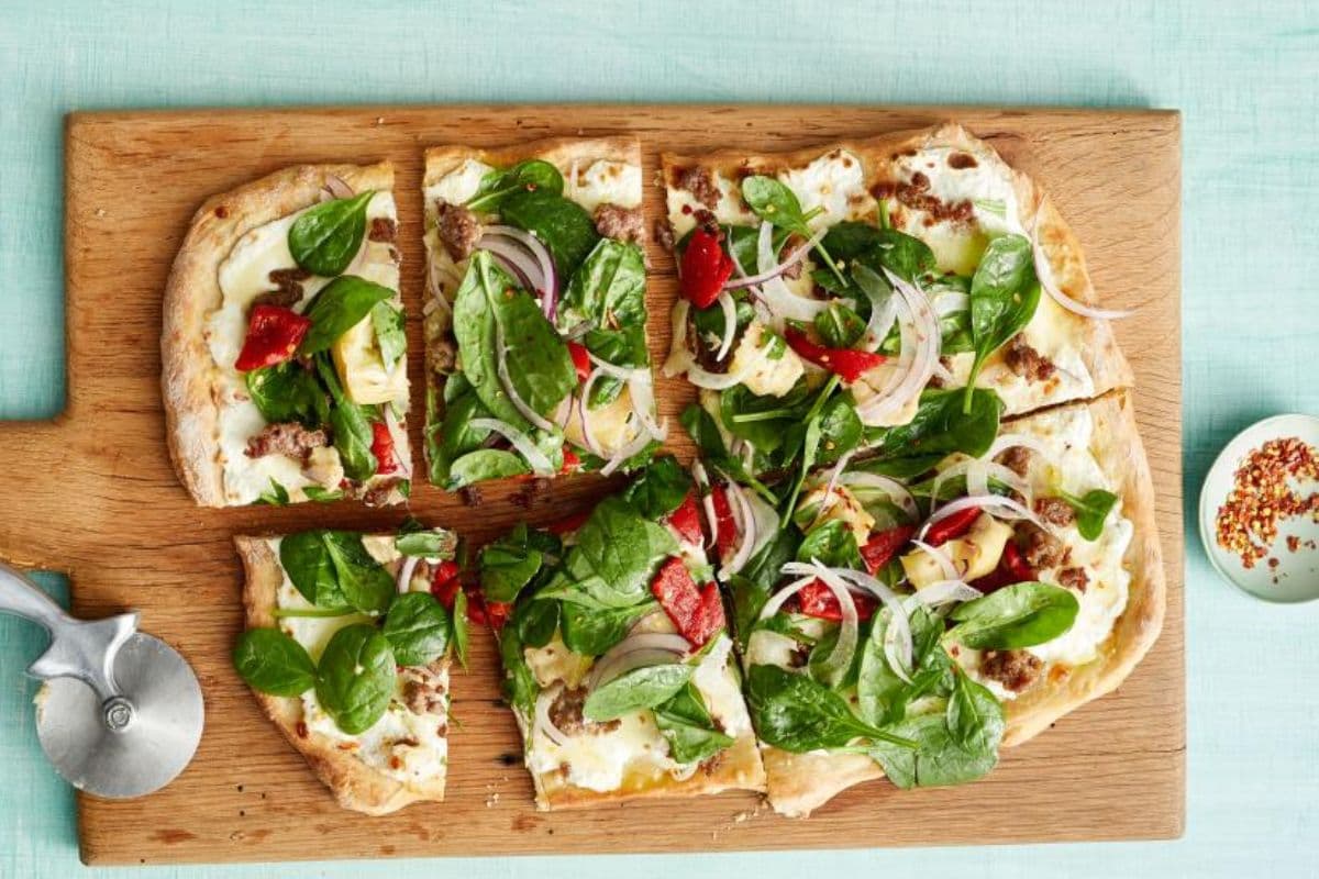 Sausage pizza with spinach salad; spring meals