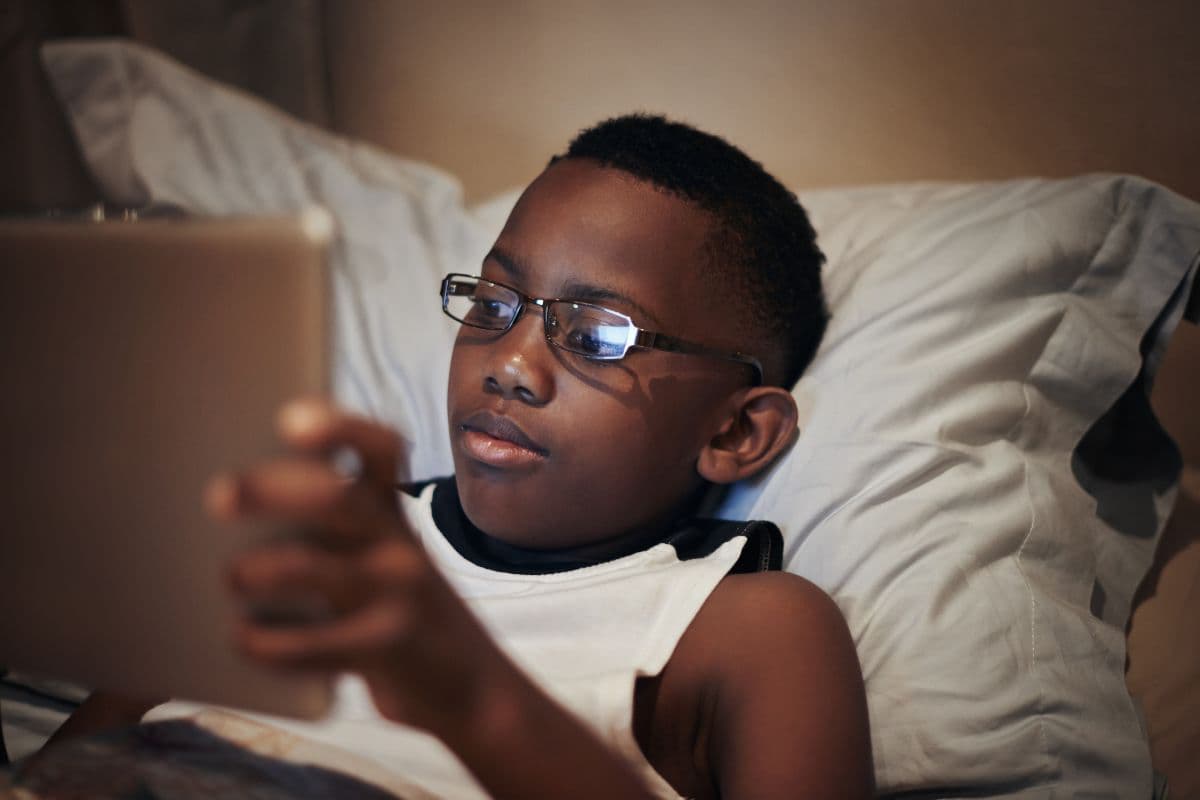 limit screens, boy on iPad in bed