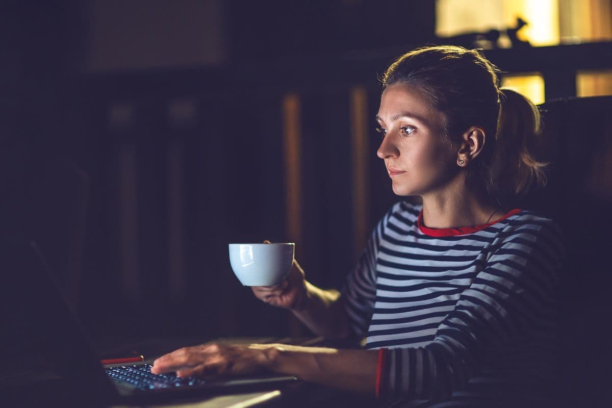 woman drinking coffee at night