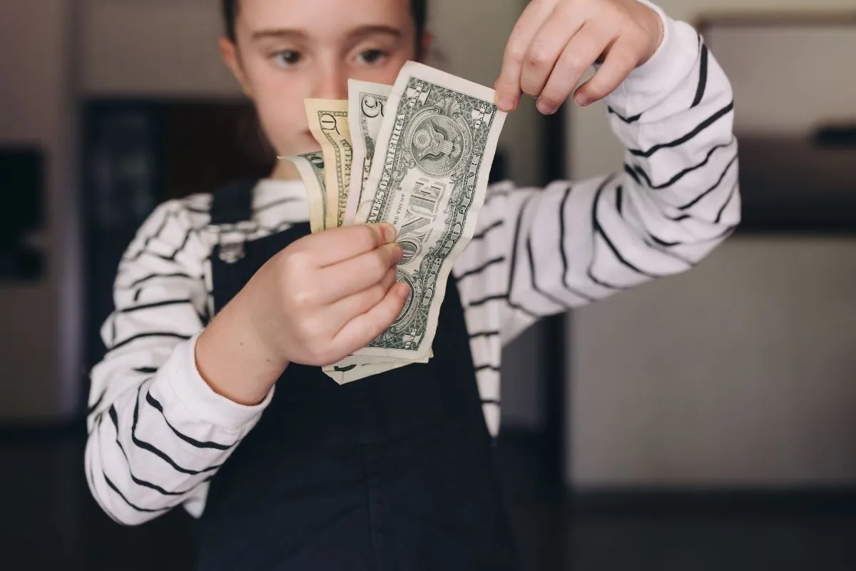 girl holding money