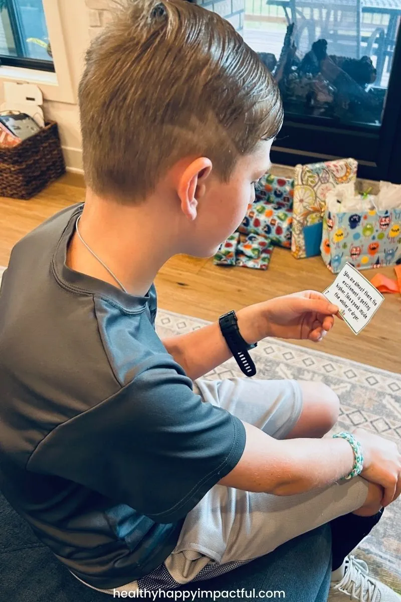 boy holding scavenger hunt card