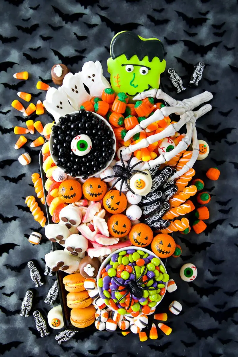 bright Halloween charcuterie board of desserts and treats