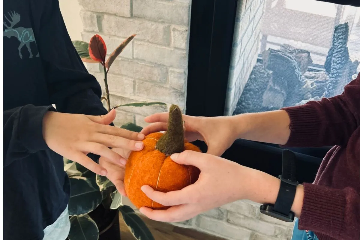 boys passing a pumpkin