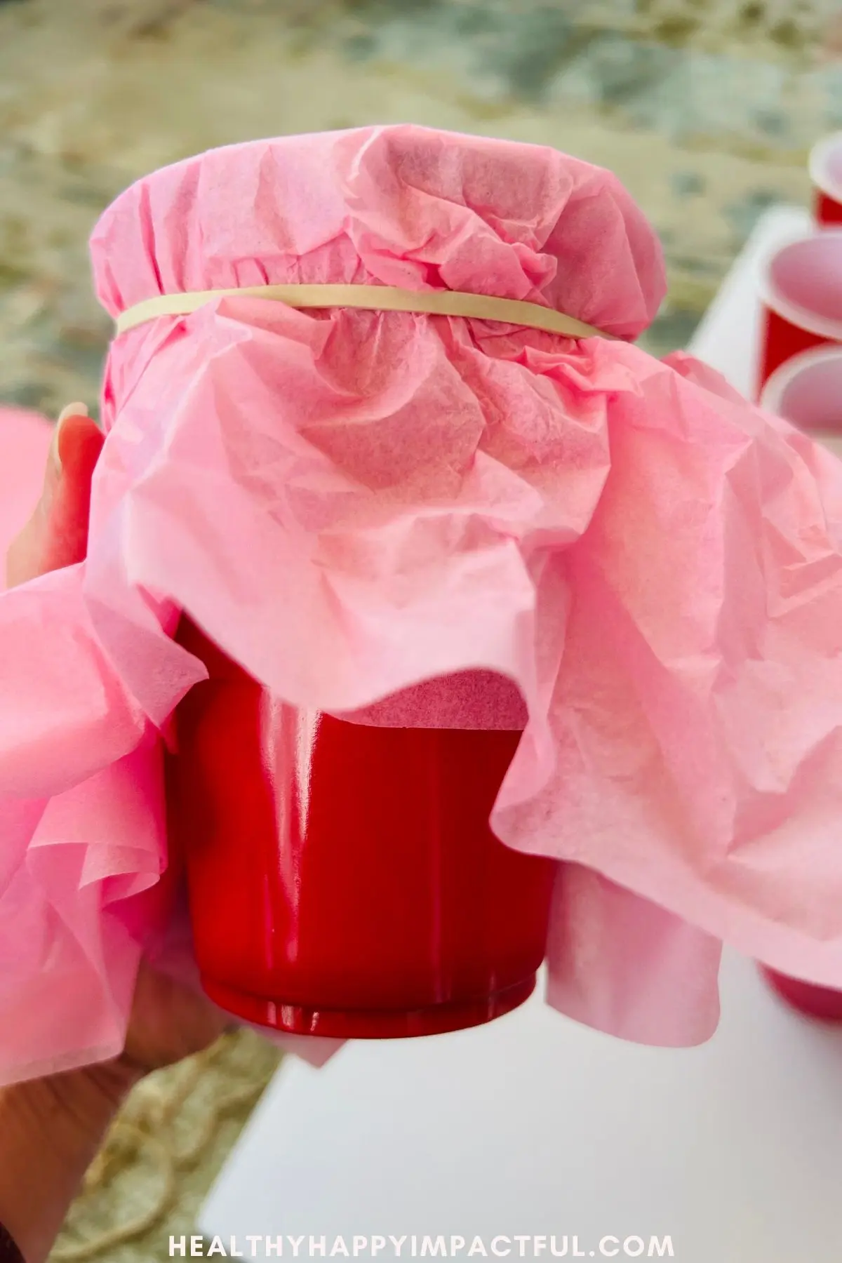 cup wrapped in rubber band