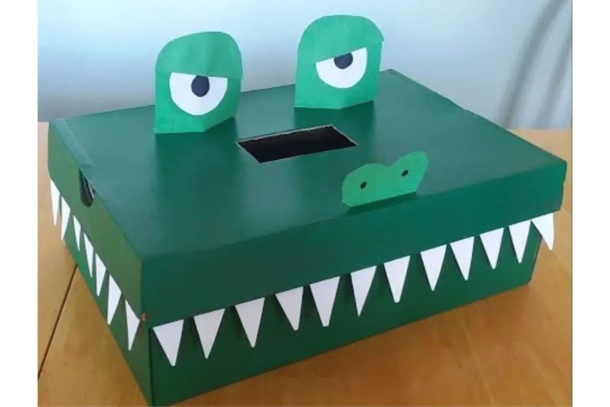 green dinosaur with teeth and eyes