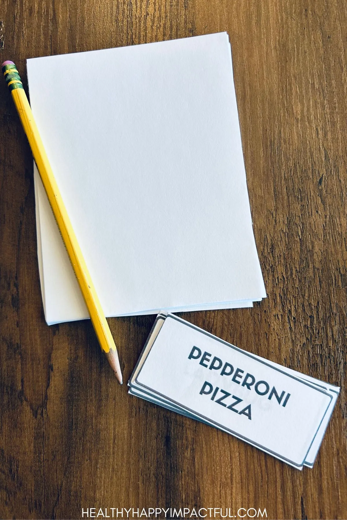 stack of paper, pencil, word cards