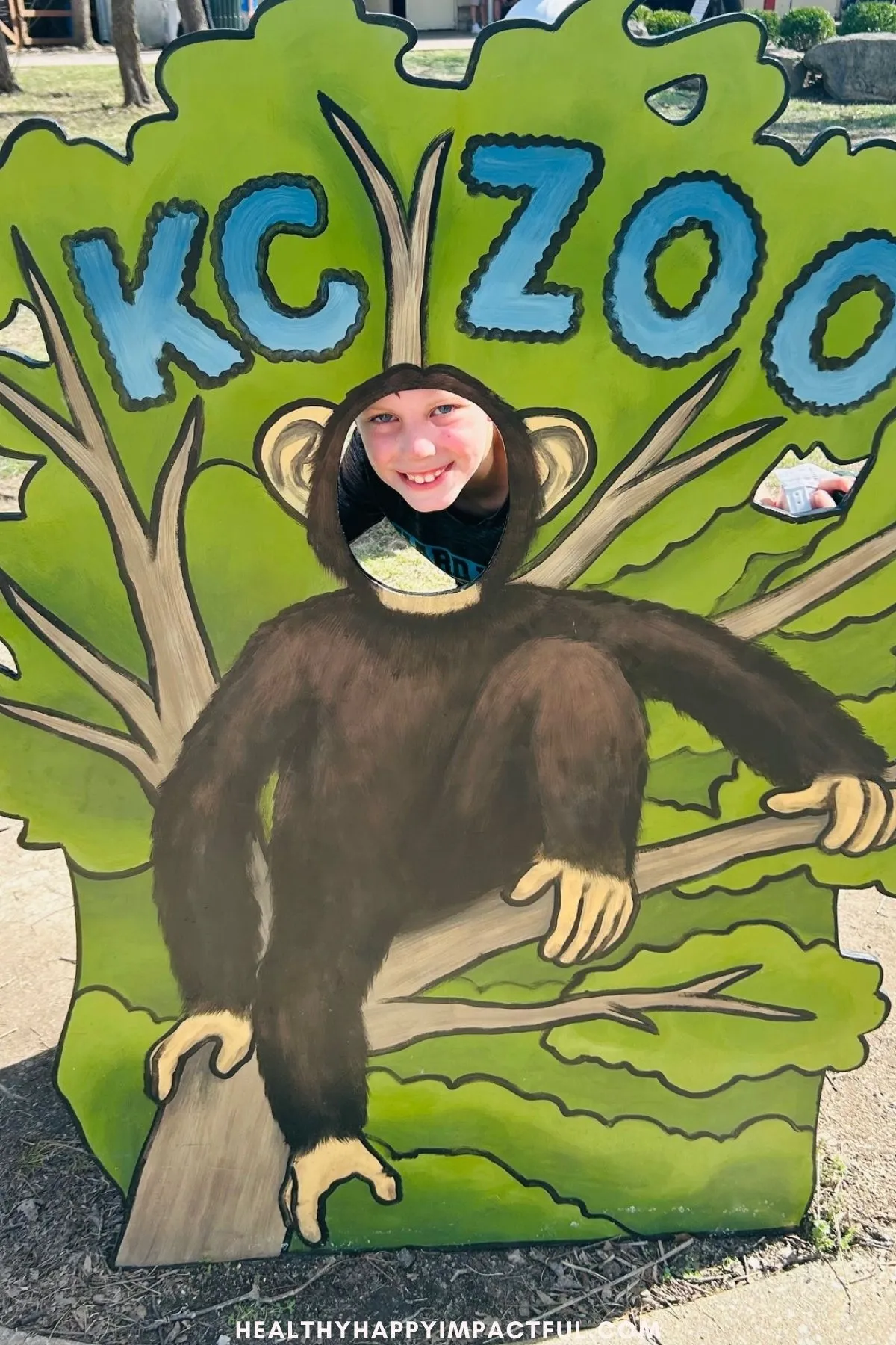 boy smiling in monkey sign