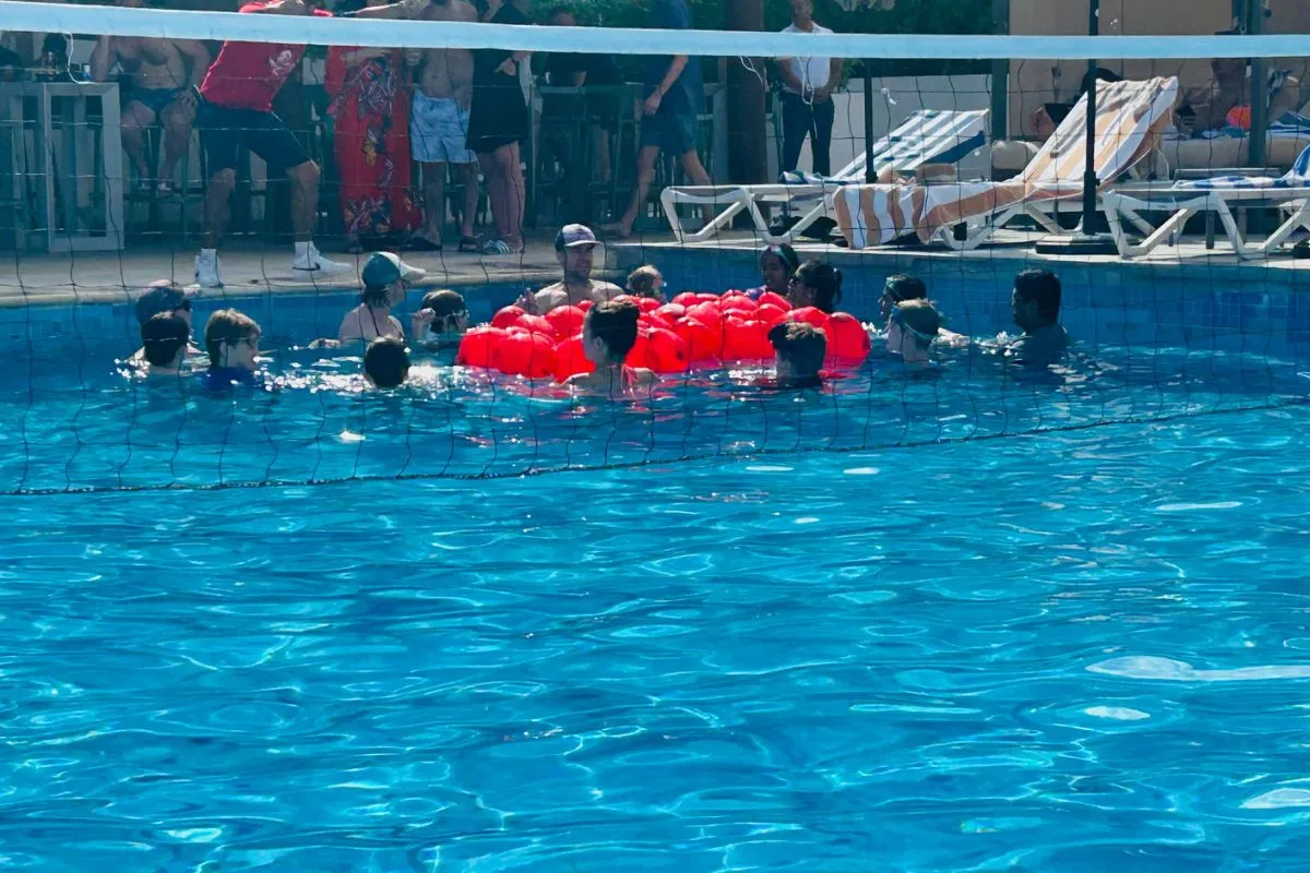 swimming pool party games for teens with a net; water balloons; volleyball