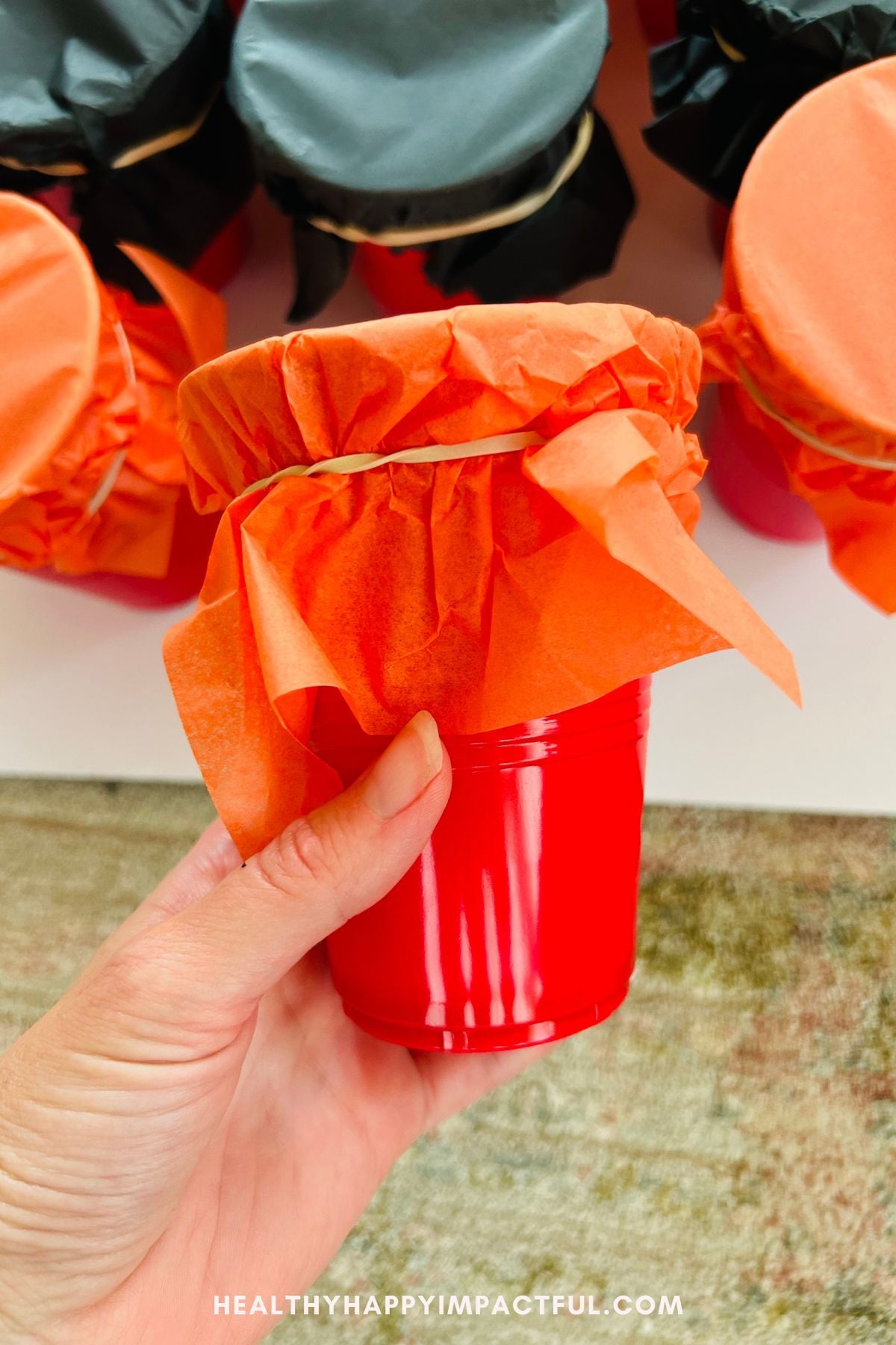 holding a cup, pumpkin making
