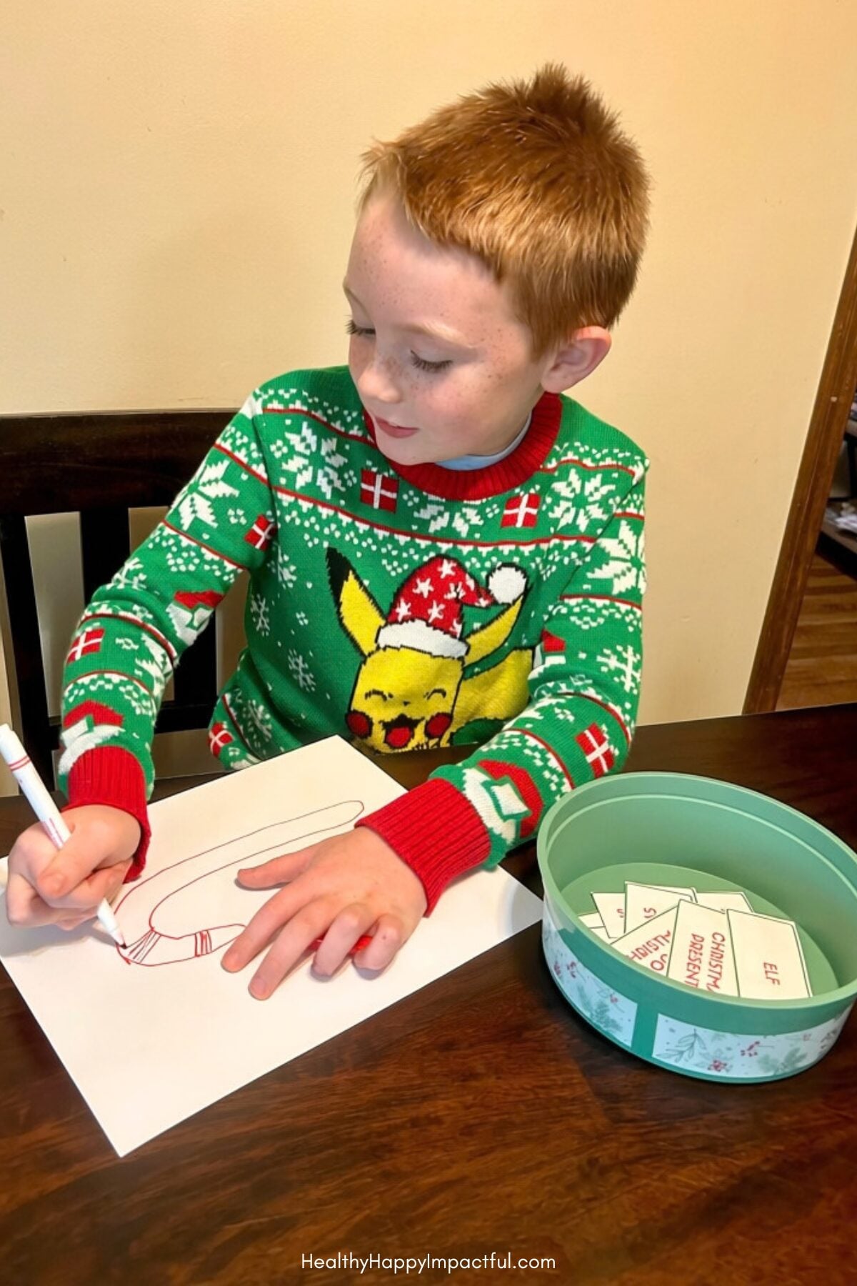 Playing holiday game Christmas Pictionary