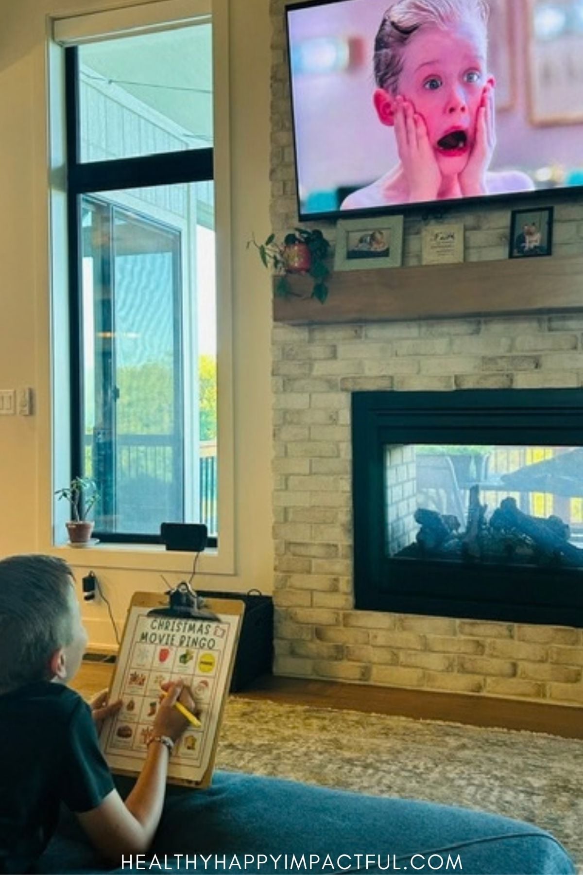 kid watching home alone movie and playing game